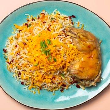 Zereshkpolo mit Huhn auf einem türkisen Teller